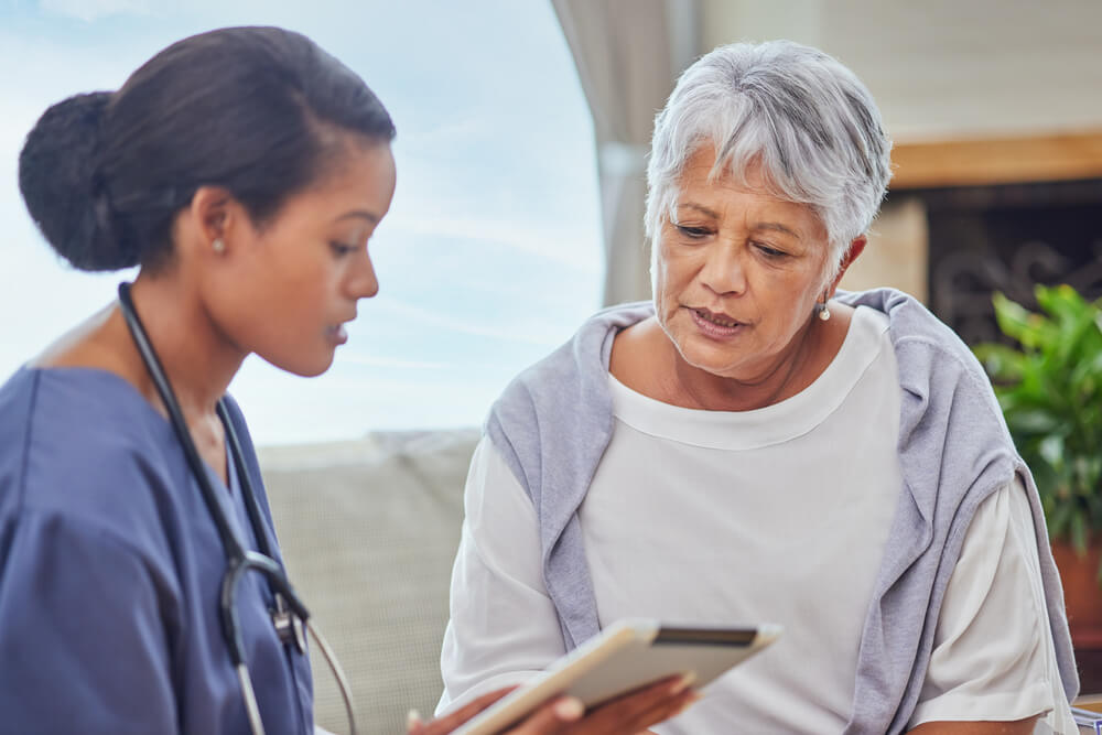 A Woman And Nurse Discuss Daily Needs With Westbrook Care Center'S Residential Care Near Excelsior Springs, Mo.